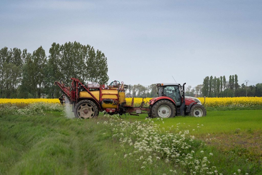 Tractor spraying field crops